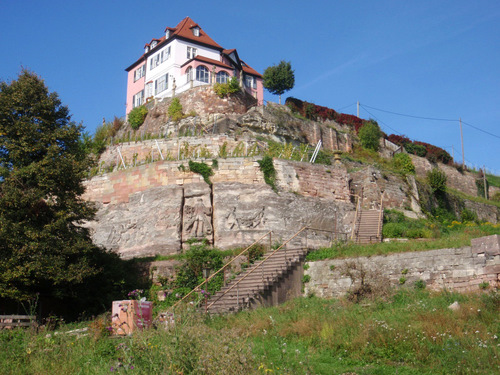 Hillside View of House and Stone Carvings.